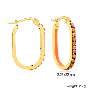 Detail view of oval gold hoop earrings with orange enamel and cubic zirconia inlay