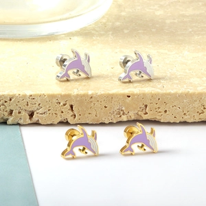 Detail shot of purple and white enamel dolphin stud earrings in gold and silver finish