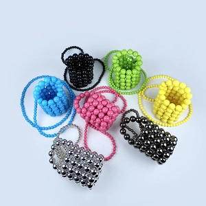 Top view of handmade mini beaded crossbody bags in seven vibrant colors and metallic finishes