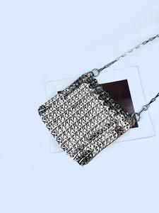 Detailed close-up of silver chainmail metal sequins on a stylish shoulder evening bag
