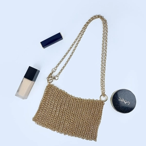 Detailed view of handmade gold metal mesh evening bag with sequin chain strap