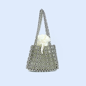 Detail of silver beaded handbag featuring a white drawstring satin lining and woven mesh