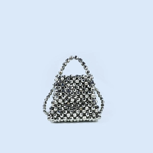 Detailed view of handmade silver beaded handbag with metallic faceted beads and handle