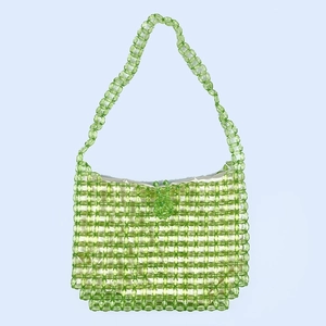 Detail of green acrylic beaded shoulder bag featuring woven texture and fabric lining