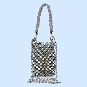 Detailed view of silver sequin handmade bag with bead texture and metal chain strap
