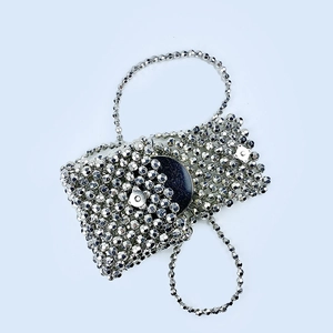 Detail of silver beaded evening bag with metallic beads and magnetic clasp closure