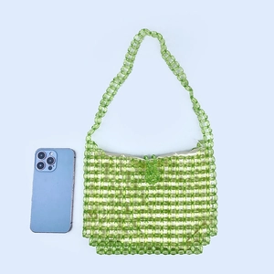 Detail of green handmade acrylic beaded shoulder bag with soft inner lining and strap