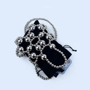 Silver beaded bag detail showing the interior black pouch and smartphone capacity