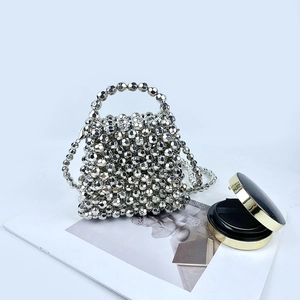 Detail of silver beaded handbag with metallic finish beads and a fine metal chain strap