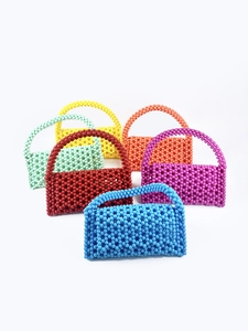 Handmade beaded handbags collection in candy colors including blue, red, and purple hues