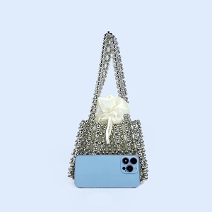 Silver beaded handbag with white satin drawstring liner and smartphone for size reference