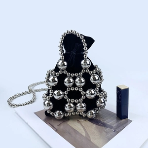 Detailed shot of beaded mesh handbag with velvet inner bag and metallic chain strap