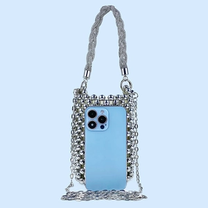 Detailed view of silver beaded handbag with phone inside showing storage and texture