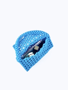 Macro detail of blue beaded bag showing interior capacity for phone and lipstick