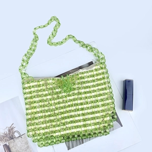 Detailed view of handmade green translucent acrylic beaded handbag with matching shoulder strap