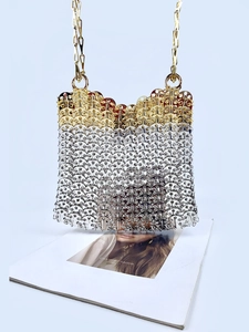 Close-up of handmade gold and silver metallic sequins on a chain evening bag