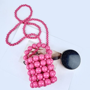 Detail of pink handmade beaded mini bucket bag with glossy acrylic pearls and strap