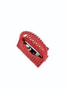 Detail view of red beaded handbag interior showing capacity for phone and cosmetics