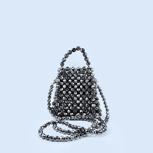Detailed view of handmade black beaded crossbody bag with faceted metallic beads
