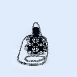 Close-up of black velvet drawstring bag with silver metallic beaded floral mesh overlay