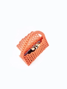 Detailed texture of vibrant coral orange hand-beaded bag with internal gold metal clasp