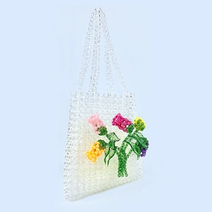 Detail of handmade beaded tote with 3D acrylic flowers and clear crystal-like pearls