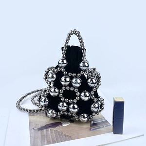 Mini black velvet drawstring bag with silver beaded mesh and lipstick for scale