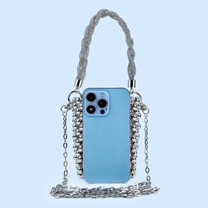 Detail of silver sequin bead bag holding a smartphone with woven strap and metal chain