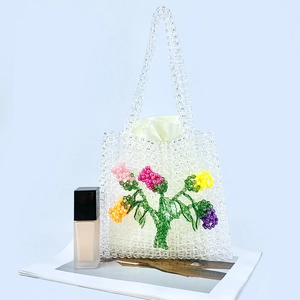 Detail of handmade clear acrylic beaded tote bag with multi-color 3D floral pattern