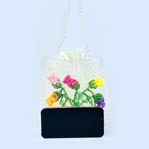 Handmade clear acrylic beaded handbag featuring colorful 3D rose patterns and twin handles