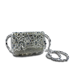 Detail showing the intricate handmade flower bead weaving on silver shoulder bag