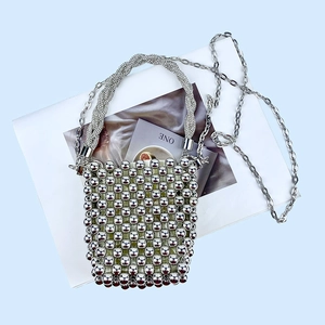 Detail view of silver sequin woven ball bag with rhinestone handle and metal chain