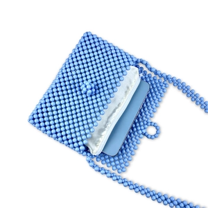 Detail of blue beaded handbag interior with silk lining and smartphone capacity display