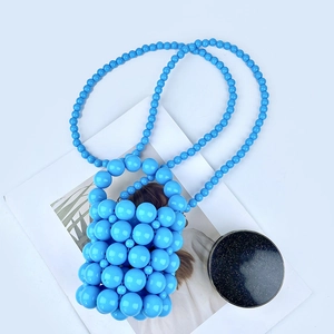 Detail of light blue handmade beaded mini bucket bag with high-gloss pearl texture