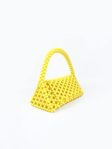 Top view of yellow handmade beaded handbag featuring unique hollow woven resin beads