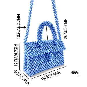Detail view of light blue beaded handbag with dimensions 19x6x12cm and shoulder strap