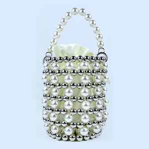 Detailed view of woven pearl bucket bag with silver beads and satin drawstring liner