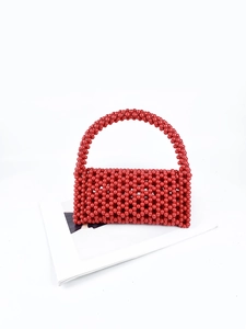 Close-up of handmade red beaded handbag with glossy circular beads and woven texture