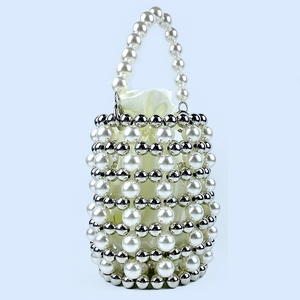 Macro detail of hand-woven pearl bucket bag with silver beads and white satin drawstring