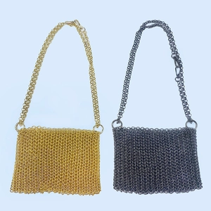 Detail of gold and dark grey metal mesh crossbody bags with sequin chain texture
