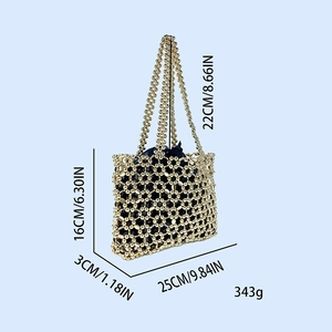 Detail of golden beaded shoulder bag with metallic hollow mesh and navy drawstring liner