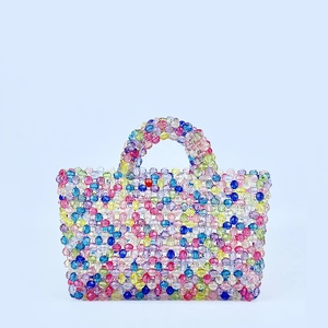 Detailed macro view of colorful handmade beaded handbag with vibrant rainbow pattern beads