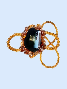 Hollow tortoiseshell beaded bucket bag with drawstring liner showing internal storage space