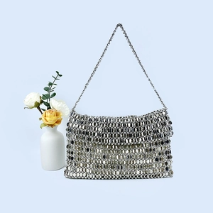 Detailed macro view of a silver sequin evening bag with reflective mirror finish