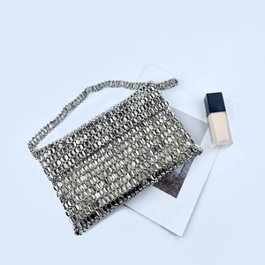 Detailed top view of handmade silver sequin beaded evening handbag on a white background