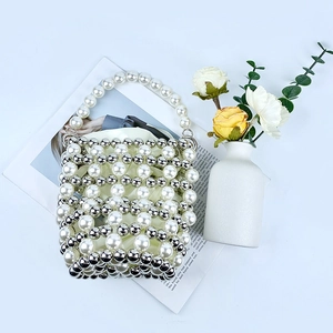 Macro shot of white and silver pearl beaded bucket bag with intricate woven texture