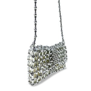 Detail of silver metallic woven mini bag featuring bamboo-shaped beads and mesh texture