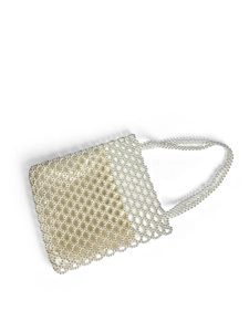 Close-up of handmade white pearl beaded handbag with mesh grid and satin lining
