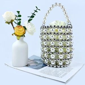 Detail of handcrafted pearl bucket bag with silver beads and satin drawstring liner