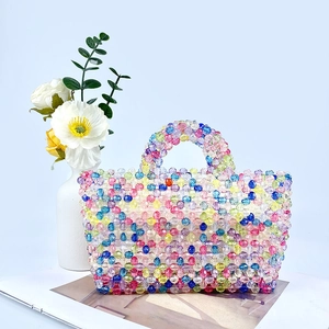 Close-up of vibrant handmade rainbow beaded tote bag with large acrylic beads